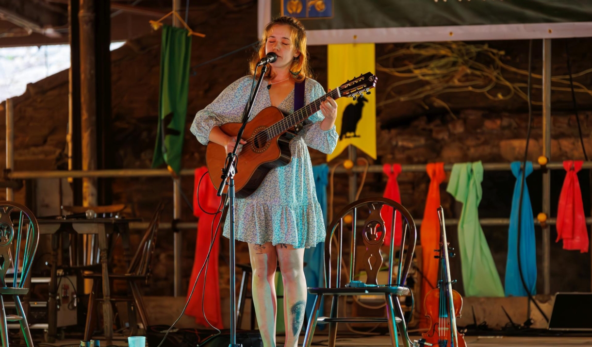 Chloe Pinney performing on the guitar.