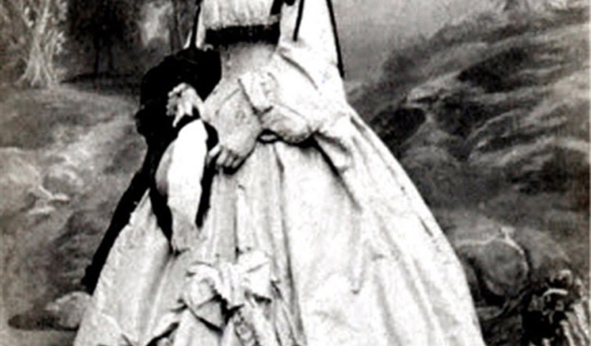 Image showing a woman in a large white dress in front of a nature background