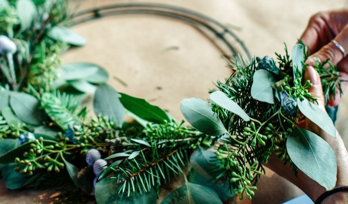 A Christmas wreath being made