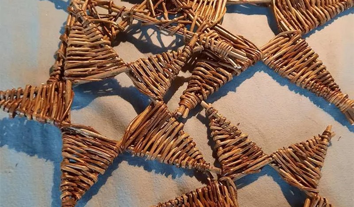 Three decorative wicker stars placed on a bed