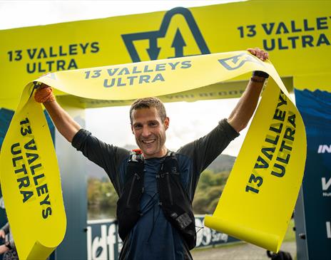 Ultra runner celebrating crossing the finish line