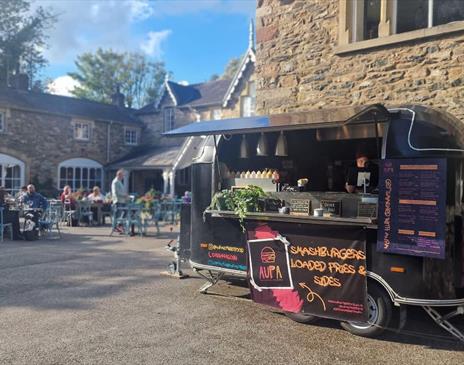 Outdoor food truck serving smash burgers