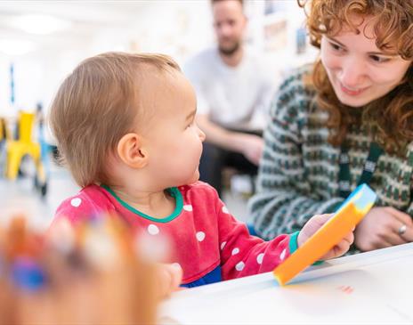 A baby and a women playing together