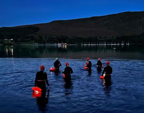 Visitors Enjoying the Stargazing Night Swim at Another Place, The Lake in Ullswater, Lake District