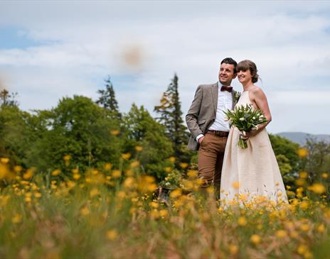 Happy Couple Posing for Wedding Photos at Armathwaite Hall Hotel and Spa in Bassenthwaite, Lake District