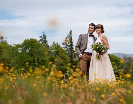 Happy Couple Posing for Wedding Photos at Armathwaite Hall Hotel and Spa in Bassenthwaite, Lake District