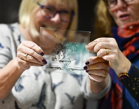 Visitors Looking at Stained Glass from the Stained & Fused Glass Friday Events at Brewery Arts in Kendal, Cumbria