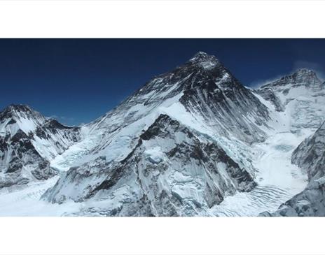 Snow-covered mountain range with deep blue sky