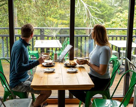 Couple enjoying lunch at at Cafe Ambio in Whinlatter Forest in the Lake District, Cumbria