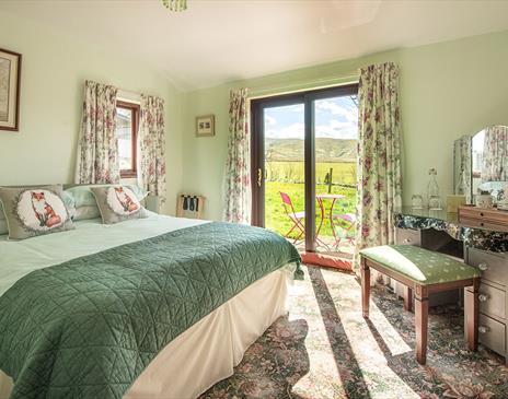 Double Bedroom with Dressing Table and Outdoor Access at High Greenside Bed and Breakfast in Ravenstonedale, Cumbria