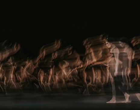 Long exposure photo of a women in a black dress