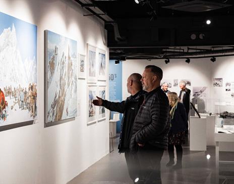 Visitors viewing artwork at the Everest Revisited Exhibition at Rheged in Penrith, Cumbria