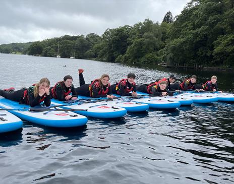 Visitors Paddleboarding with Genuine Adventures in the Lake District, Cumbria