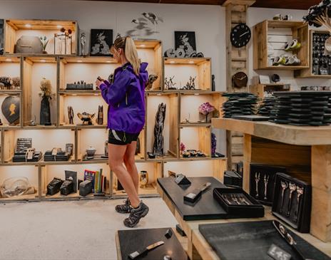 Visitor browsing shop at at Honister Slate Mine in Borrowdale, Lake District
