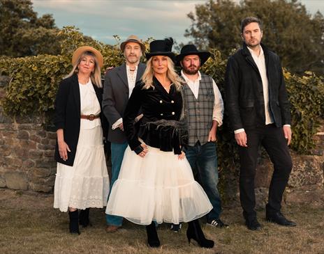 Fleetwood Nick'd stood infront of a stone wall