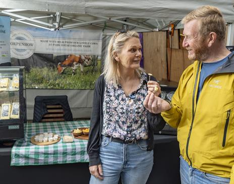 Visitors at a Stall at Keswick Saturday Market in the Lake District, Cumbria