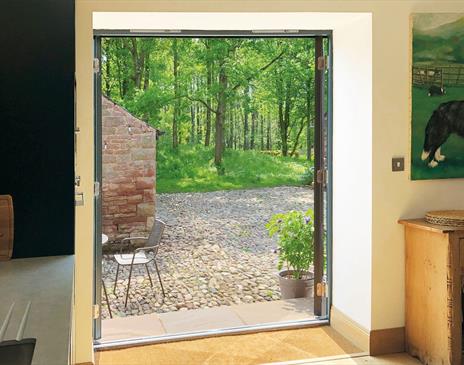 Double doors leading outside at The Barn at Linden Farm House in Langwathby, Cumbria