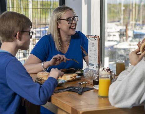 Family having food & drink at Marina View Cafe in Maryport, Cumbria