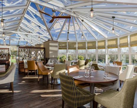 Dining Tables and Seating at The Conservatory at The Melbreak Hotel in Great Clifton, Cumbria