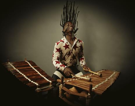 Photo of a man playing a wooden percussion instrument