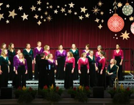A choir on stage all looking in different directions