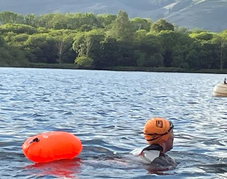 Visitor swimming in Derwentwater with Swim on the Wild Side in Keswick, Lake District