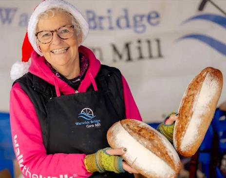 Vendor Posing with Bread at Taste Cumbria Christmas in Cockermouth, Lake District