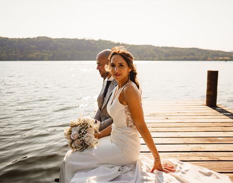 Bridal Couple posing for portraits at a Wedding at The Ro Hotel in Bowness-on-Windermere, Lake District