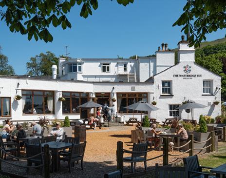Visitors using outdoor seating at The Wateredge Inn in Ambleside, Lake District