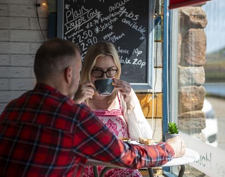 Visitors having coffee at The Wharf Ice Cream and Coffee House in Maryport, Cumbria