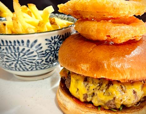 Burger with chips and onion rings from The Last Zebra in Carlisle, Cumbria