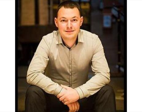 A photo of Edward Taylor sitting down