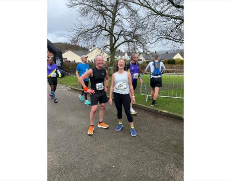 two runners smiling after completing a race
