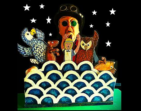 A puppeteer holding up character from the children book "Alice in Wonderland"