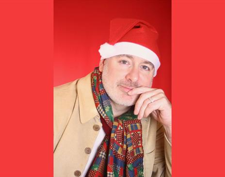 A close up of a man wearing a santa hat