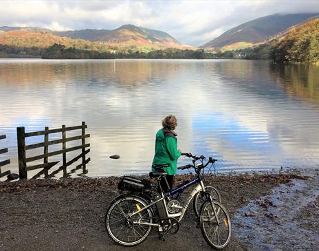 Cyclist Standing Lakeside on a Cycling Holiday in the Lake District, Cumbria from The Carter Company