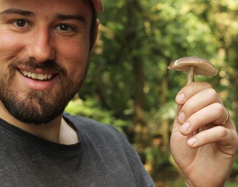 Jim from Forage Box, posing with a foraged mushroom