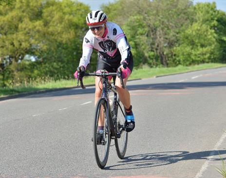 Female cyclist riding on a road