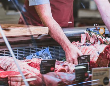 Chris Russell with beef at the butchers counter at Cranstons Orton Grange Food Hall near Carlisle, Cumbria