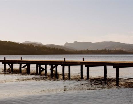 A photo by Juliet Klottrup of a wooden jetty outstretched over a lake in Cumbria