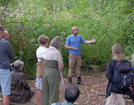 A man holding a Foraging workshop outdoors