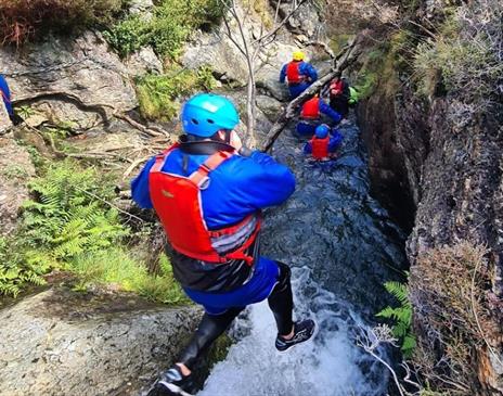 Visitors ghyll scrambling with Newlands Adventure Centre in the Lake District, Cumbria