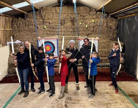 Family doing archery at Newlands Adventure Centre in the Lake District, Cumbria