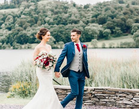 Bridal couple walking on the grounds of Daffodil Hotel & Spa in the Lake District, Cumbria