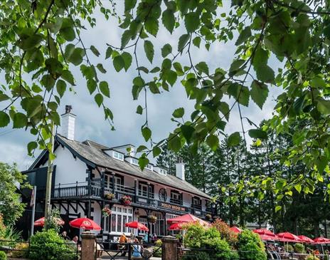 Exterior and lush plants in the summer at Pooley Bridge Inn in the Lake District, Cumbria