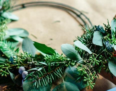 A Christmas wreath being made