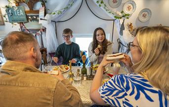 Family enjoying food and drink at The Fairydust Emporium in Silloth, Cumbria
