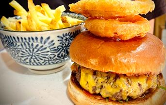 Burger with chips and onion rings from The Last Zebra in Carlisle, Cumbria