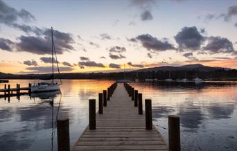 View from a Jetty over Windermere with a Dramatic Sunset in the Lake District, Cumbria