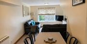 Dining area and living room in Number 9 at Howgills Apartments in Sedbergh, Cumbria